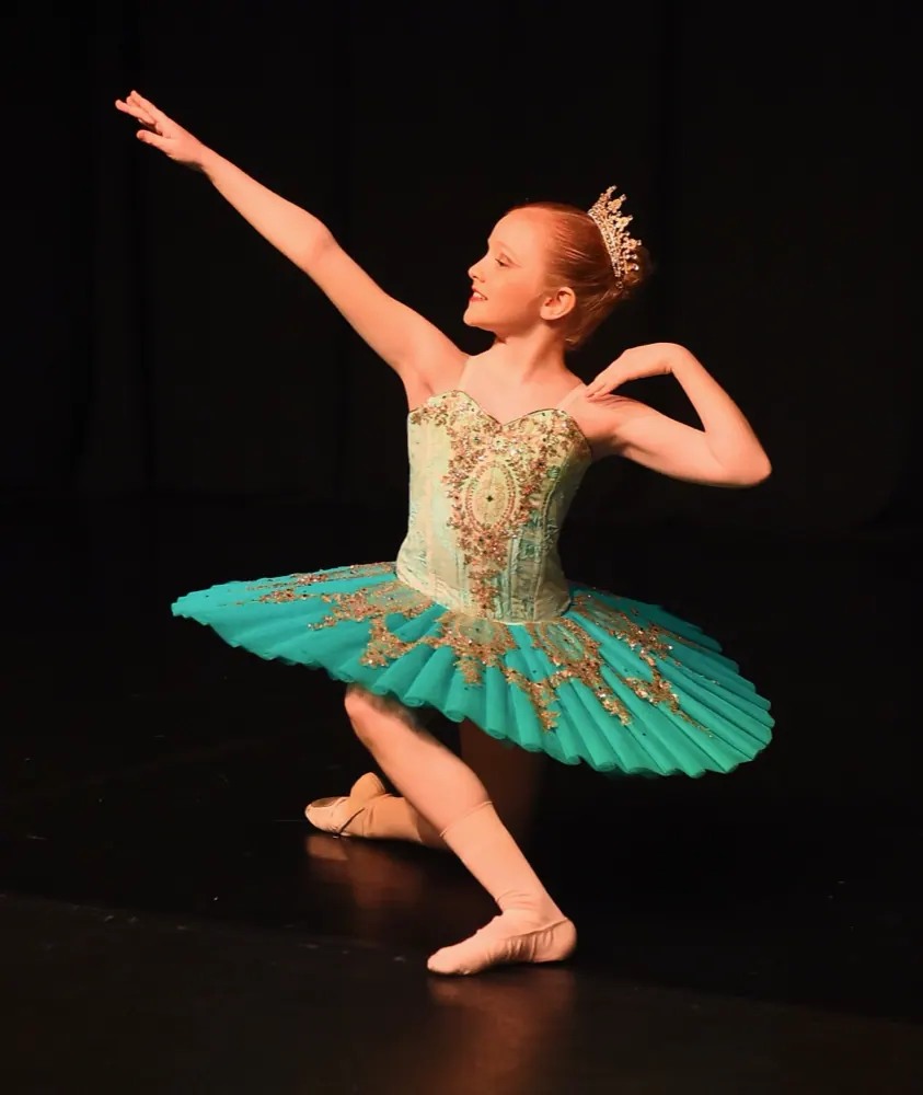 A ballerina in a teal tutu